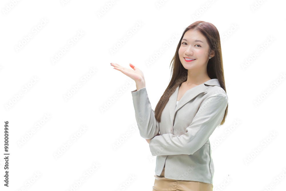 Young Asian professional working woman with long hair in a grey suit smiles happily and show her hand to presents something while isolated white background. Young Asian professional working woman with long hair in a grey suit smiles happily and show her hand to presents something while isolated white background.