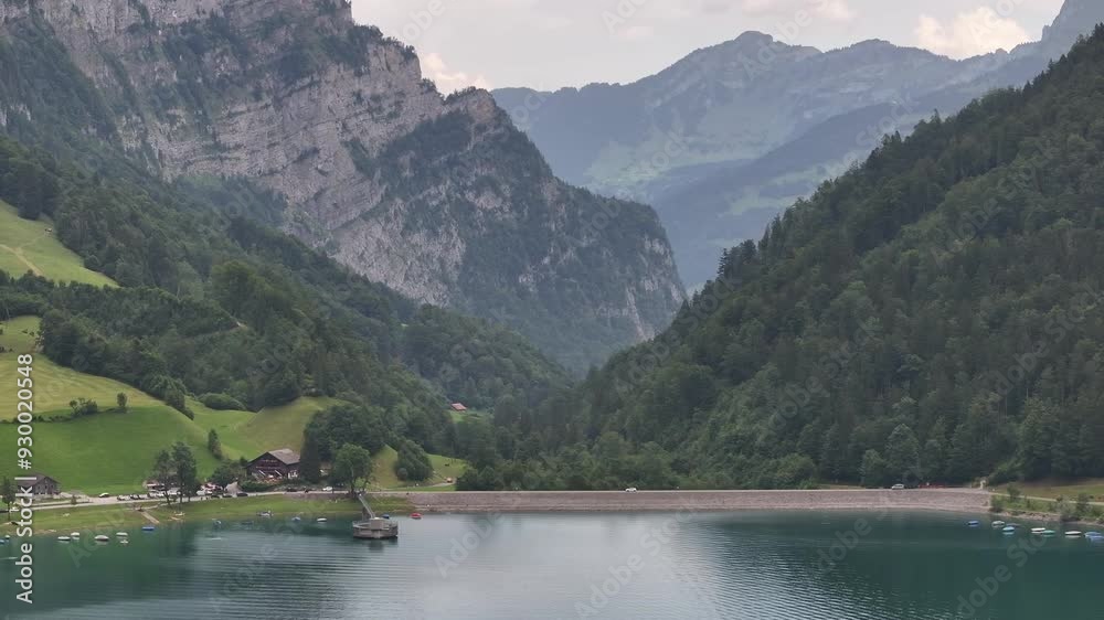Panaromic drone view of Klöntalersee Vorderglärnisch Glarus Schweiz of the lake - boats floating over the lake in Klöntalersee Vorderglärnisch Glarus Schweiz Panaromic drone view of Klöntalersee Vorderglärnisch Glarus Schweiz of the lake - boats floating over the lake in Klöntalersee Vorderglärnisch Glarus Schweiz
