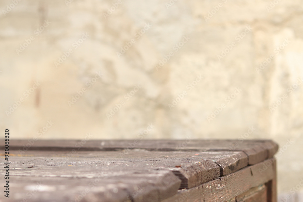 Wooden plank table with blurred concrete wall background, selective focus. Empty old table and wall for product display or installation Wooden plank table with blurred concrete wall background, selective focus. Empty old table and wall for product display or installation