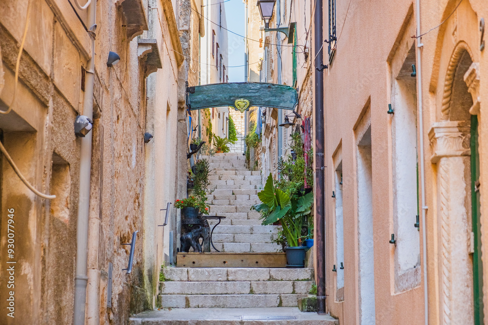 Romantic narrow stone street in town of Rab, Croatia