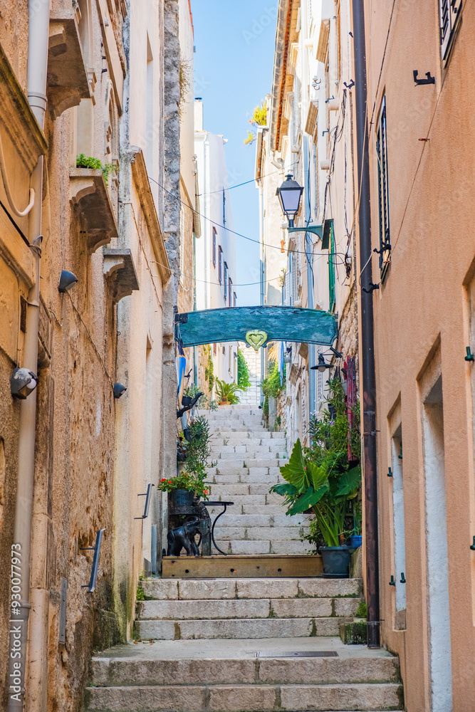 Romantic narrow stone street in town of Rab, Croatia