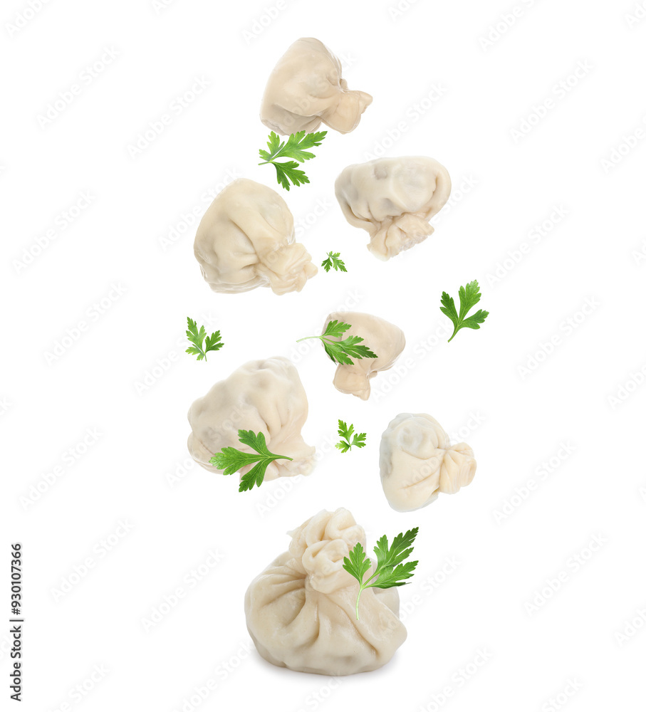 Fototapeta premium Delicious khinkali (Georgian dumplings) and parsley falling on white background