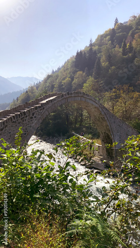 Çamlıhemşin, Rize, Turkey, 15 October 2021. Stone bridge on Firtina Stream in Camlihemsin, Rize. Beautiful nature landscape. Historical Senyuva, Cinciva bridge in Black Sea region Turkey.