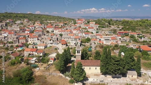 Drone aerial view of Gornje Selo, Solta, showcasing traditional stone houses, winding streets, and surrounding lush landscapes on the island photo