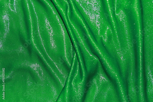 Abstract background of green fabric texture. Dimensional background and wavy surface