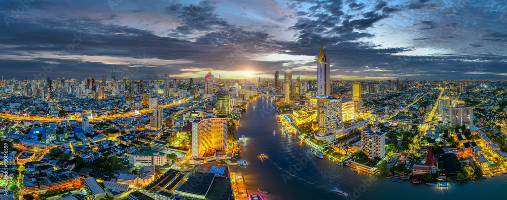 Fototapeta premium Aerial view of Skyscrapers Buildings over financial business district in Bangkok Downtown with Chao Phraya River Background. Asian tourist travel attraction city skyline, Traffic and transportation. 