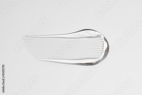 Pure transparent cosmetic gel smear on white background, skin care glycerin texture. top view