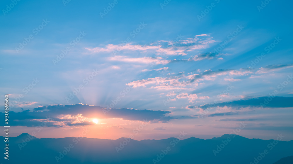 The setting sun over the mountains, the beautiful sun's rays shine through the clouds, the natural background, freedom, tranquility and peace The setting sun over the mountains, the beautiful sun's rays shine through the clouds, the natural background, freedom, tranquility and peace