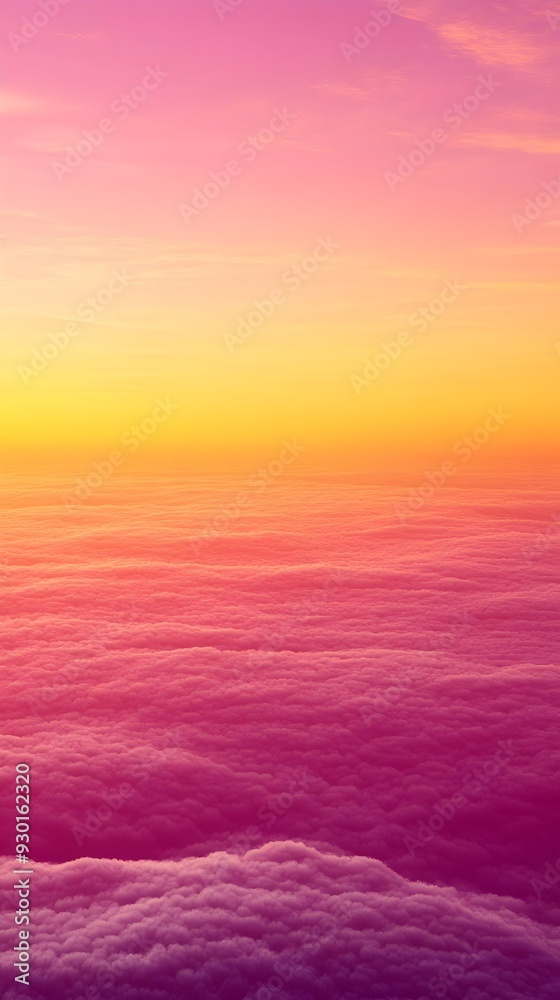 Fototapeta premium A breathtaking view of a colorful sunset over a sea of clouds, painted with shades of pink, yellow, and orange.