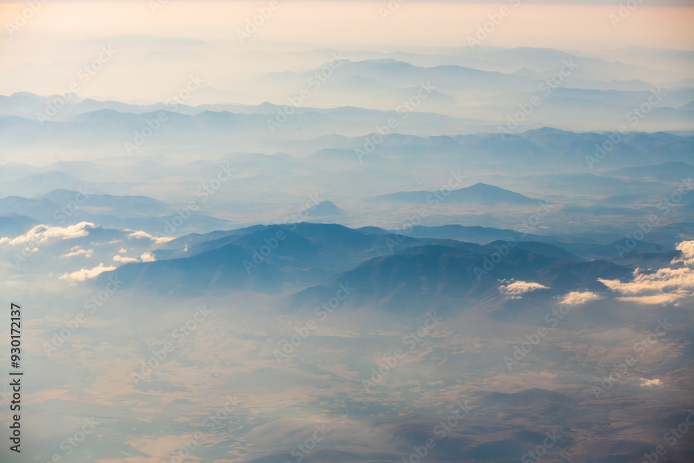 Fototapeta premium A view of the planet Earth, a view from an airplane, mountains and clouds