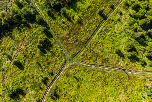 Crossroads of dirt roads in a field, aerial view. Choosing a direction on a trip