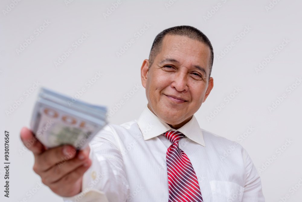A middle aged asian businessman, bank manager or professional offers a generous cash loan or payment. Isolated on a white background. A middle aged asian businessman, bank manager or professional offers a generous cash loan or payment. Isolated on a white background.