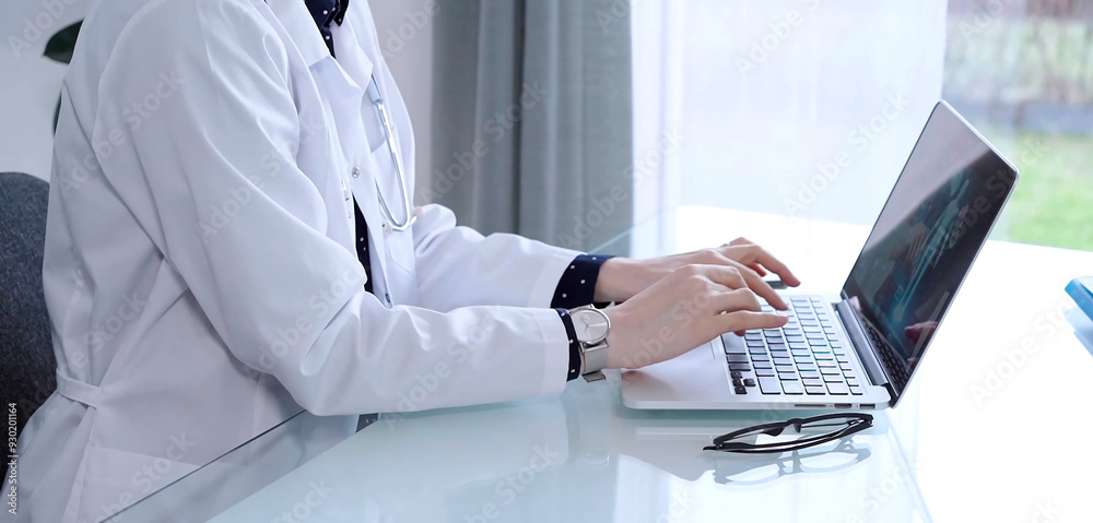 Doctor woman is sitting and typing on laptop computer, hands close up. Medicine and healthcare concept Doctor woman is sitting and typing on laptop computer, hands close up. Medicine and healthcare concept