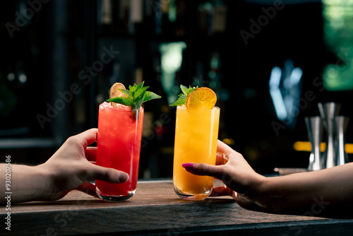 Close up of two people cheering cocktails in bar or disco club drinks and cocktails concept photo