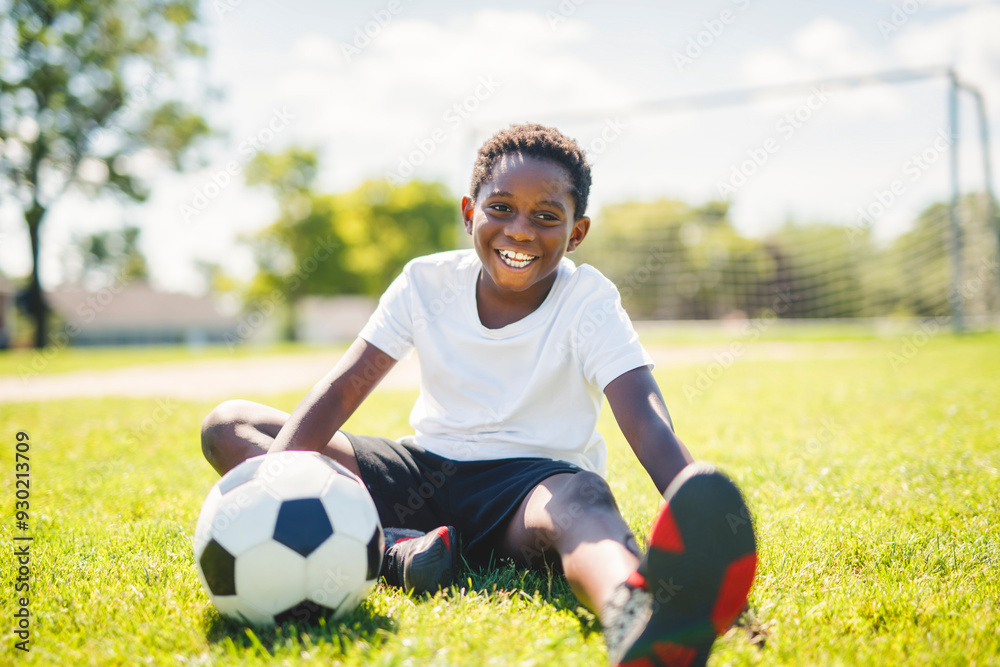 Young kid playing soccer on a playfield Young kid playing soccer on a playfield