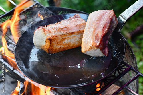 焚き火で肉の塊を焼く photo