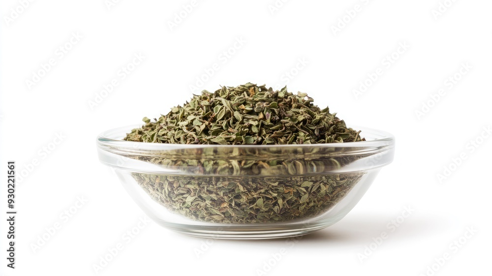 A front view of a glass bowl filled with dried oregano, isolated on a white background, with the vibrant green and brown hues of the herb clearly visible. A front view of a glass bowl filled with dried oregano, isolated on a white background, with the vibrant green and brown hues of the herb clearly visible.