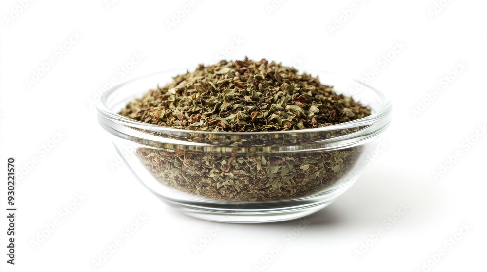 A front view of a glass bowl filled with dried oregano, isolated on a white background, with the vibrant green and brown hues of the herb clearly visible. A front view of a glass bowl filled with dried oregano, isolated on a white background, with the vibrant green and brown hues of the herb clearly visible.