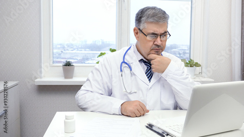 Male doctor looking at computer screen