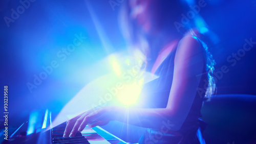 Photography Silhouette of artistic woman performing fortepiano in blue stage light and dramatic smoke