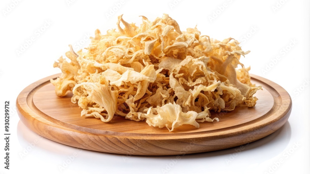 Isolated on a clean white background, a delicate arrangement of dried white fungus rests on a rustic wooden plate, showcasing its intricate, earthy beauty. Isolated on a clean white background, a delicate arrangement of dried white fungus rests on a rustic wooden plate, showcasing its intricate, earthy beauty.