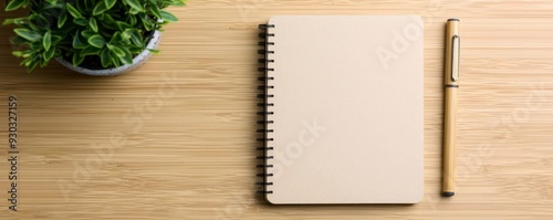 Recycled paper notebook with a pen made of bamboo, eco-friendly office supplies, sustainable workspaces photo