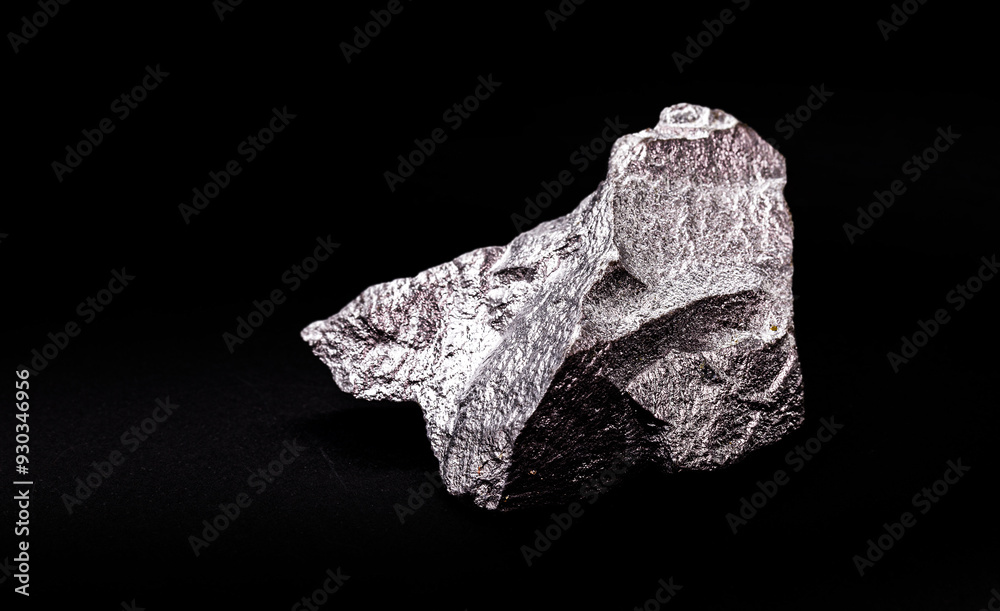 raw zinc nugget on isolated black background, metal used in allo