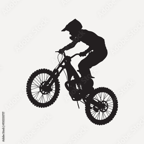 Mountain biker silhouette performing jump
