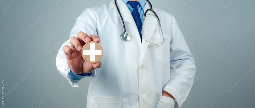 Doctor showing circle wood plank and plus sign represents medical health care and doctor staff service concept, Insurance in health care and medicine concept. Doctor showing circle wood plank and plus sign represents medical health care and doctor staff service concept, Insurance in health care and medicine concept.