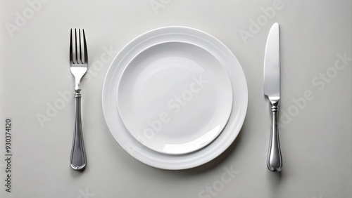 A minimalist white plate with a silver knife and fork arranged neatly above, creating a classic and elegant dinner setting icon.