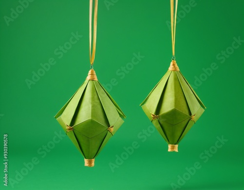 3D Realistic Hanging Green Ketupat in Solid Green Background. Ketupat is Element for Ramadan and Eid Celebration in Indonesia and Malaysia photo