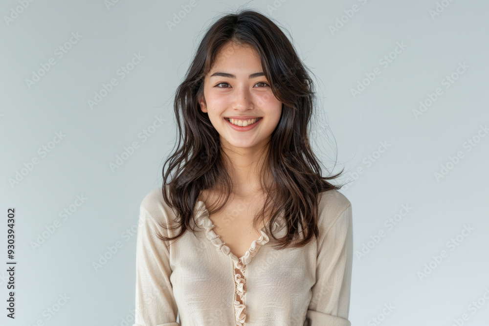 With a blend of casual and professional attire, this woman exemplifies modern office fashion while maintaining a clean, simple style.