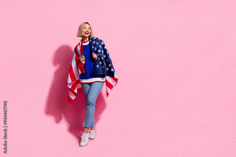 Full body length photo of thin blonde girl holding us flag having fun national holiday independence day isolated on pink color background Full body length photo of thin blonde girl holding us flag having fun national holiday independence day isolated on pink color background