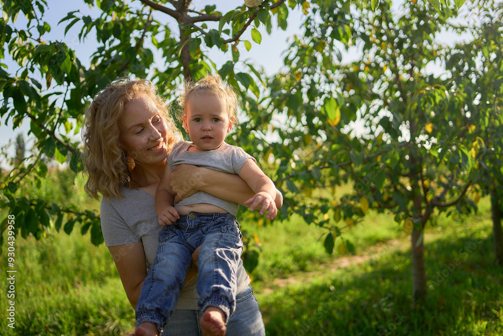 Fototapeta premium a family of four is playing catch bubbles in the garden