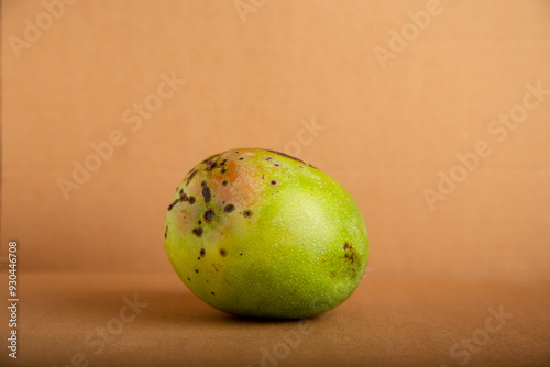 mango verde afectado por el hongo Elsinoe mangiferae, o roña photo