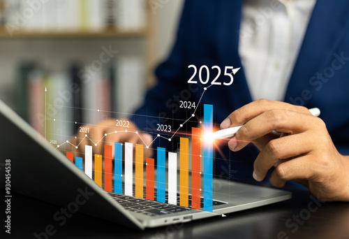 2025 financial strategy, Businessman analyzing profitability of working companies with digital augmented reality Graphics in 2025, plan long-term investments for business growth and success. photo