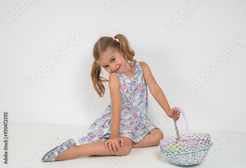 Girl in dress with tails on head on white background..Beautiful wicker basket. photo