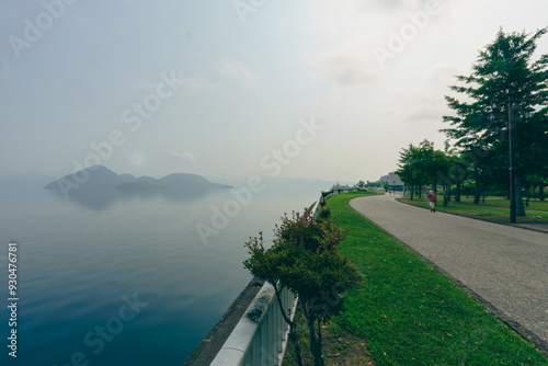 Park and people exercising close Toya lake or Toyako, Hokkaido, Japan photo