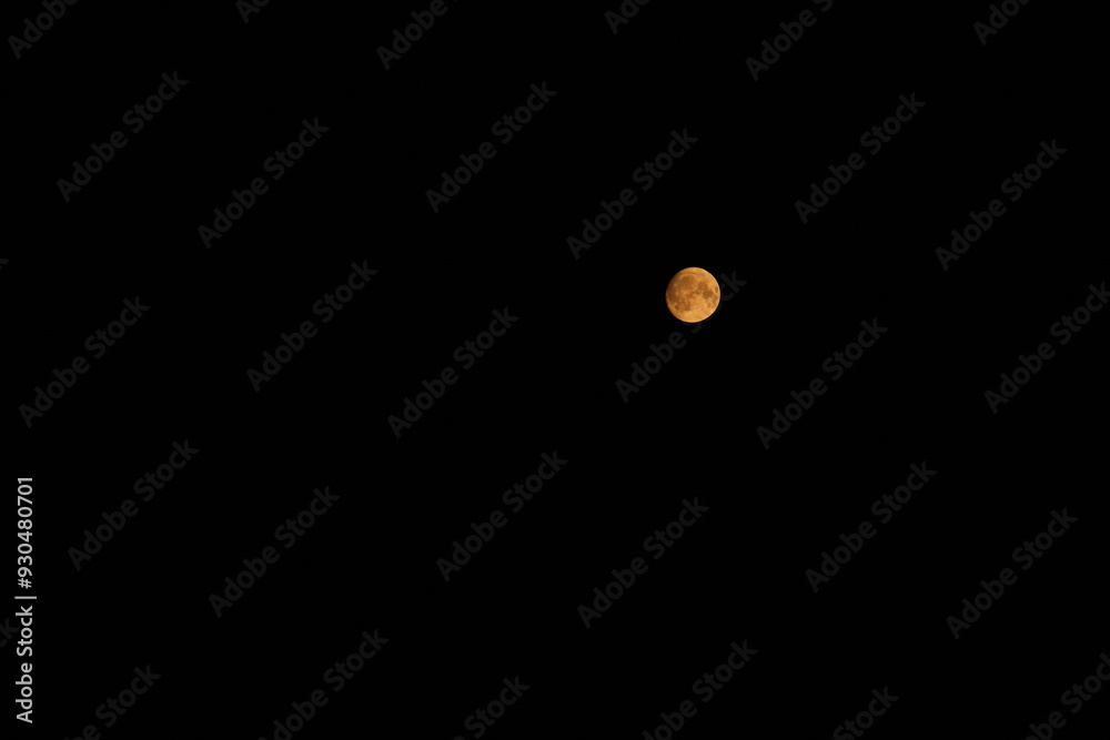 A round full yellow moon with a clear texture shines in the black night sky, creating an atmosphere of mystery and tranquility A round full yellow moon with a clear texture shines in the black night sky, creating an atmosphere of mystery and tranquility