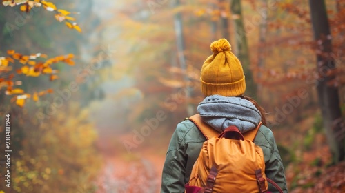 Woman Walking Through Autumn Forest with Backpack