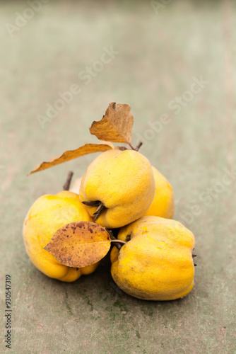 Ripe quince on a vintage wooden background