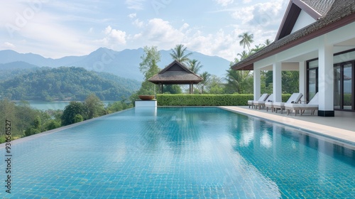 A large house with a pool and a lot of trees in the background