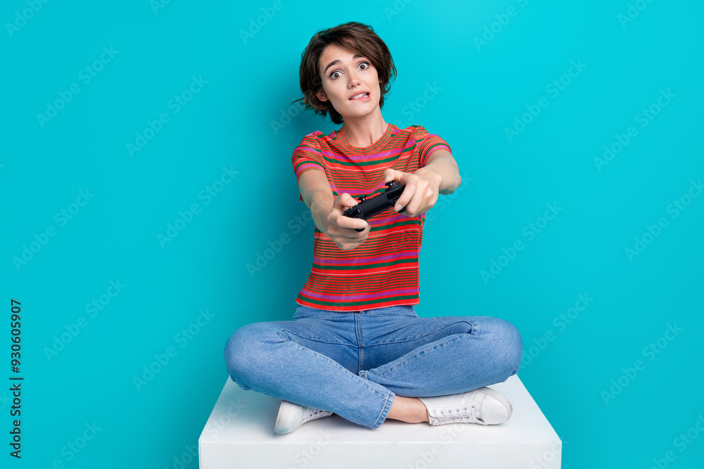 Photo of cute adorable girl wearing trendy clothes spending free time playing online video game isolated on cyan color background Photo of cute adorable girl wearing trendy clothes spending free time playing online video game isolated on cyan color background