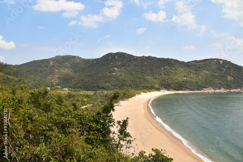 A stretch of sandy beach along the Hong Kong coastline on Lantau Island.