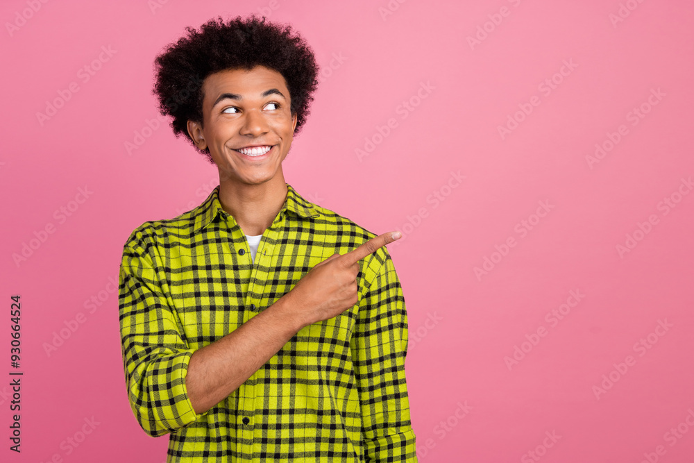 Portrait of nice young man indicate finger empty space wear shirt isolated on pink color background Portrait of nice young man indicate finger empty space wear shirt isolated on pink color background