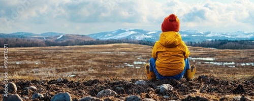 A child gazing over a barren landscape, representing the effects of climate change on future generations
