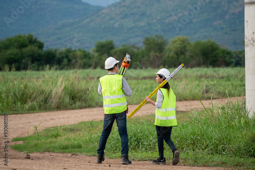 Εκτύπωση καμβά Two engineers wearing safety vests and holding surveying equipment