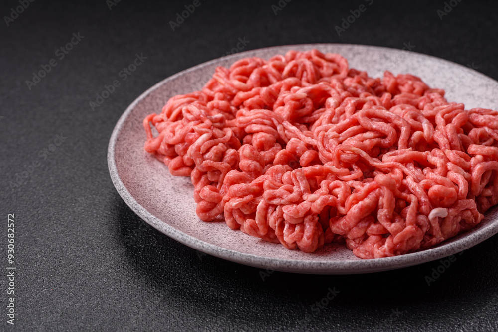 Fresh raw ground beef with salt and spices Fresh raw ground beef with salt and spices