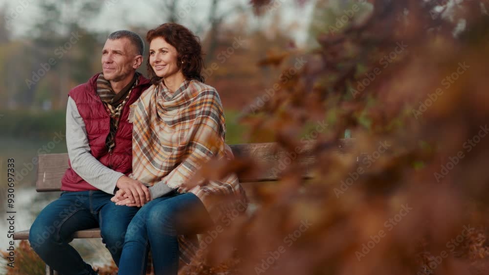 Hello autumn. smiling stylish couple in the park having fun time while sitting on bench. Hello autumn. smiling stylish couple in the park having fun time while sitting on bench.