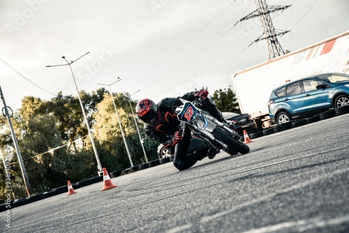 motorcyclist riding at high speed on an urban road, a person in motorcycle gear next to an off-road bike, and a racer leaning into a turn on a track